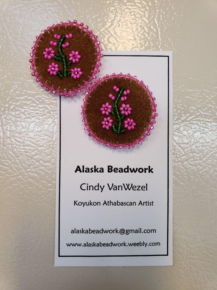 two pink and brown beaded flowers are on a card with the name alaska beadwork