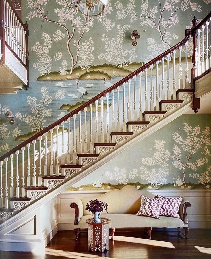 the stairs are painted with blue and white wallpaper, along with a couch in front of it