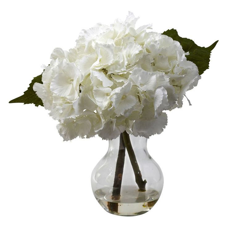 a vase filled with white flowers on top of a table