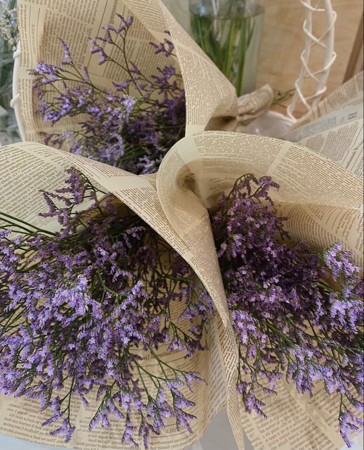 purple flowers are wrapped in burlock and placed on top of each other