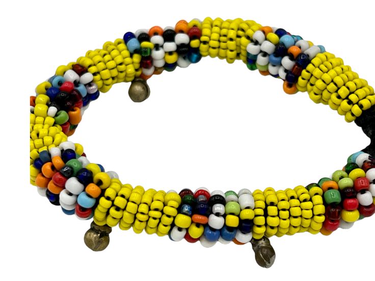 This beautiful bracelet can be worn on its own or layered with some of your other favorite pieces. It adds a pop of color to any outfit. Details: Push button clasp. Size: length of beaded portion: ~ 7.25" (18 cm), end to end: 8" (20 cm), widest portion ~1/4" (0.6 cm) Material: seed beads with brass accents and button clasp Bohemian Hand-strung Yellow Bracelet, Bohemian Yellow Hand-strung Bracelet, Festival Yellow Friendship Bracelets With Colorful Beads, Multicolor Beaded Braided Bracelet For Festivals, Bohemian Heishi Beads Colorful Bracelets, Unique Hand-strung Beaded Bracelets For Festivals, Multicolor Spacer Beads Wrap Bangle Bracelet, Multicolor Braided Bracelets With Round Beads For Festival, Multicolor Spacer Beads Wrap Bracelet