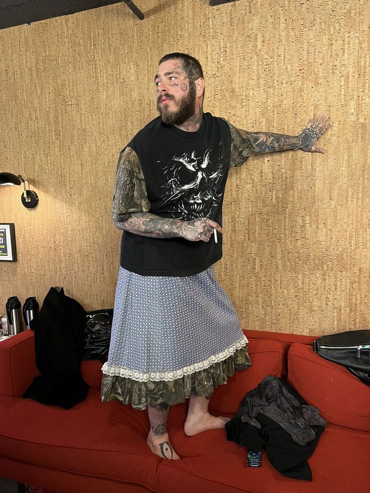 a man standing on top of a red couch