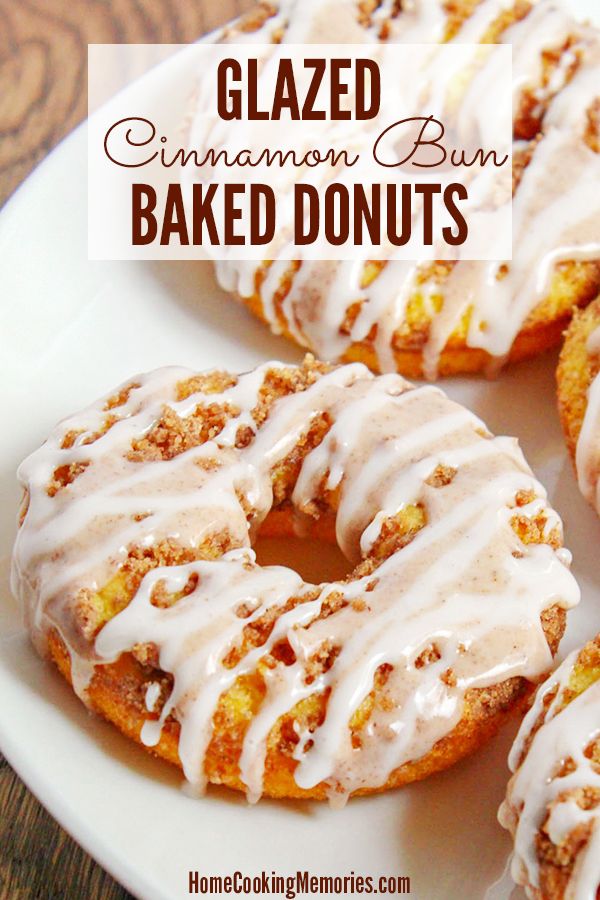 glazed cinnamon buns with icing on a white plate next to another donut