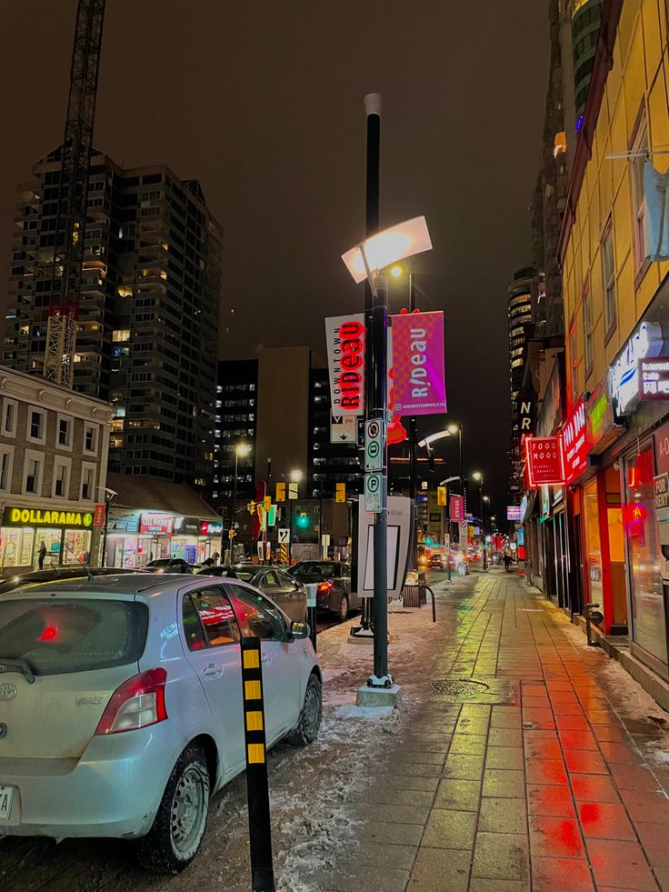 a city street with cars parked on the side of it