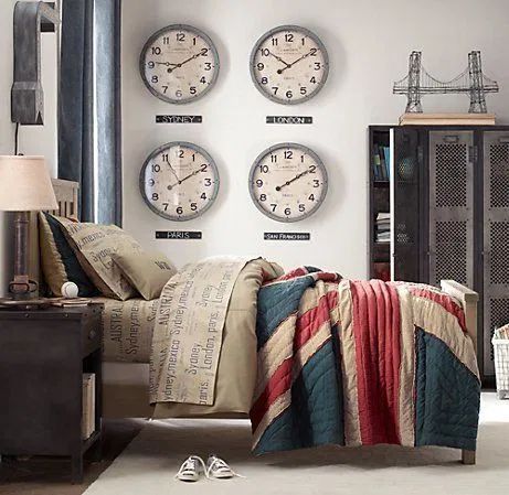 three clocks on the wall above a bed