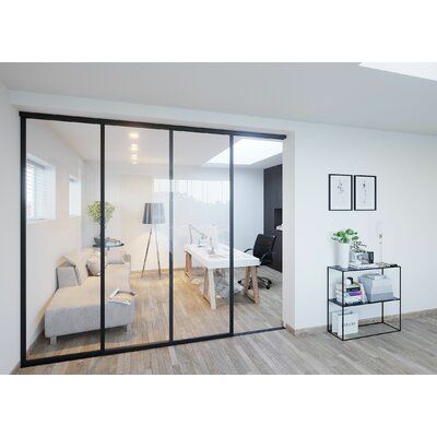 an office with white walls and wooden floors is seen through the glass doors to another room