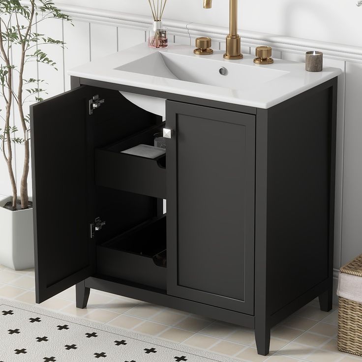 a bathroom sink sitting next to a black cabinet