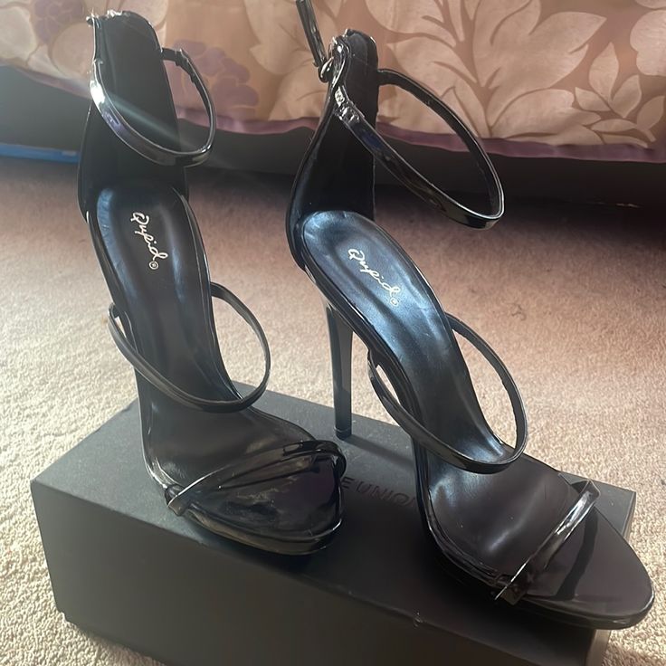 Black Heels , Never Worn. Sleek Heels With Heel Loop For Night Out, Sleek Open Heel Heels For Night Out, Black Heels With 4-inch Heel And Ankle Strap, Sleek Heels With Heel Loop For Party, Sleek High Heel Shoes For Date Night, Sleek Party Heels With Heel Loop, Sleek High Heels For Date Night, Black Ankle Strap Heels With Branded Heel Counter, Sleek Block Heel Shoes For Night Out