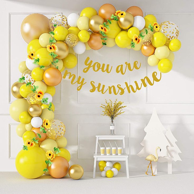 the balloon arch is decorated with yellow and white balloons that say you are my sunshine