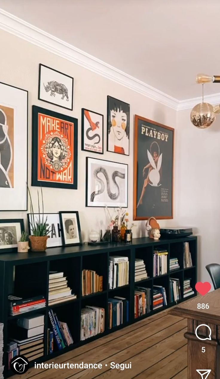 a living room filled with lots of furniture and pictures on the wall above it's bookshelf