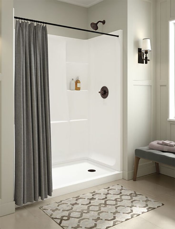 a bathroom with a shower and rug on the floor