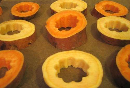 several pieces of fruit sitting on top of a baking sheet with holes in the middle