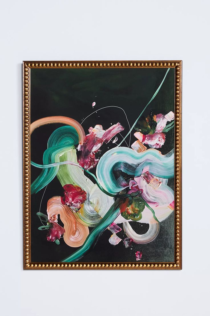 a painting hanging on the wall next to a white wall with a gold frame and flowers