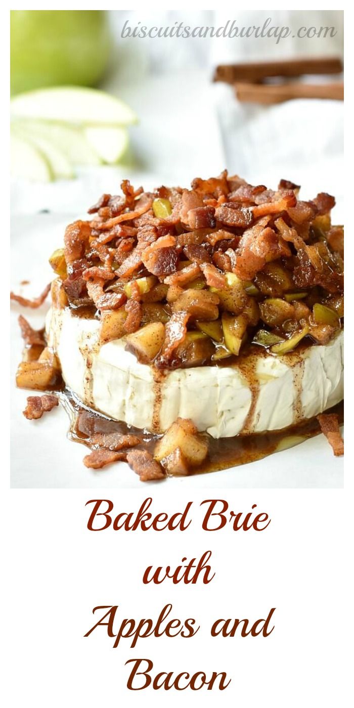 baked brie with apples and bacon is on a white plate next to an apple