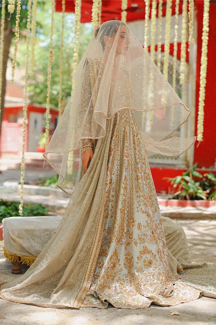 "Exude elegance in this metallic silver hued peshwas cut from tissue, featuring a scalloped hem and detailed zardoze work in a silver and gold composition. A tissue dupatta with sprinkled sequins and zardoze worked borders is paired with a matching handworked tissue brocade lehnga." Tissue Dupatta, Scalloped Hem, Beautiful Outfits, Veil, Borders, Custom Sizing, Metallic Silver, Composition, Silver