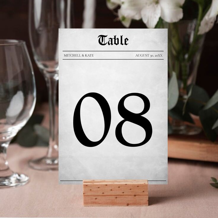 a table number is placed next to some wine glasses