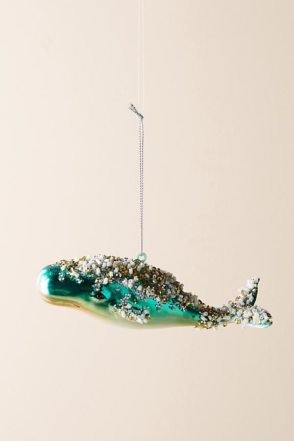 a glass ornament hanging from a string in the shape of a whale's tail