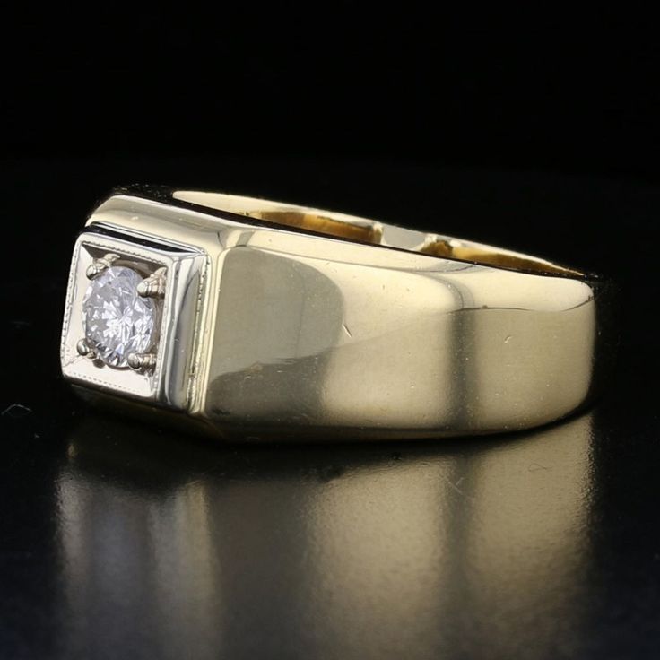 This striking vintage men's ring is a testament to timeless elegance. Crafted from 14K yellow gold, it features a round-cut diamond at its center, graded J for color, offering a subtle, classic brilliance. With a substantial weight of 13.83 grams, this piece combines luxury and durability, making it a perfect statement piece for the modern gentleman. Specifications: Metal: 14K Yellow Gold Weight: 13.83 grams Diamond: Round Cut, J Color Style: Vintage Men's Ring Size: 7.5 Classic Diamond Ring With Polished Finish, Classic Yellow Gold Signet Ring With Single Diamond, Classic Gold Diamond Signet Ring, Classic Diamond White 14k Stamped Signet Ring, Classic Diamond White Diamond Ring With Polished Finish, Classic Formal Signet Ring, Classic Yellow Gold Signet Ring With Brilliant Cut, Classic Diamond White Round Signet Ring, Classic 14k Gold Signet Ring With Diamond