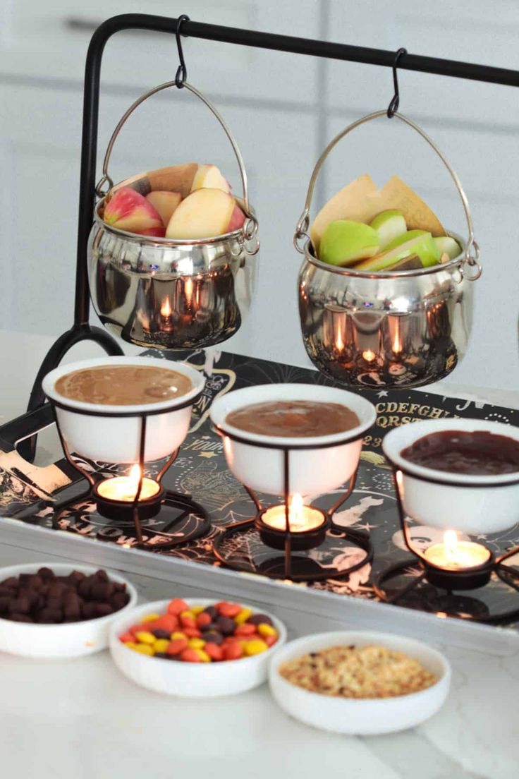 a table topped with bowls filled with different types of desserts and fruit on top of it