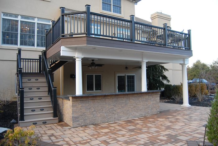 a two story house with stairs leading up to the second floor