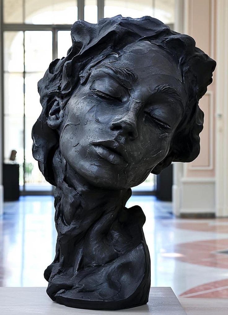 a sculpture of a woman's head is shown in the middle of a room