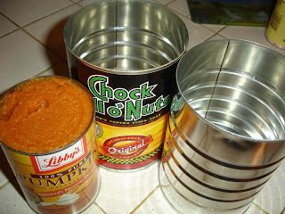 three tins with food in them sitting on the floor next to some other items