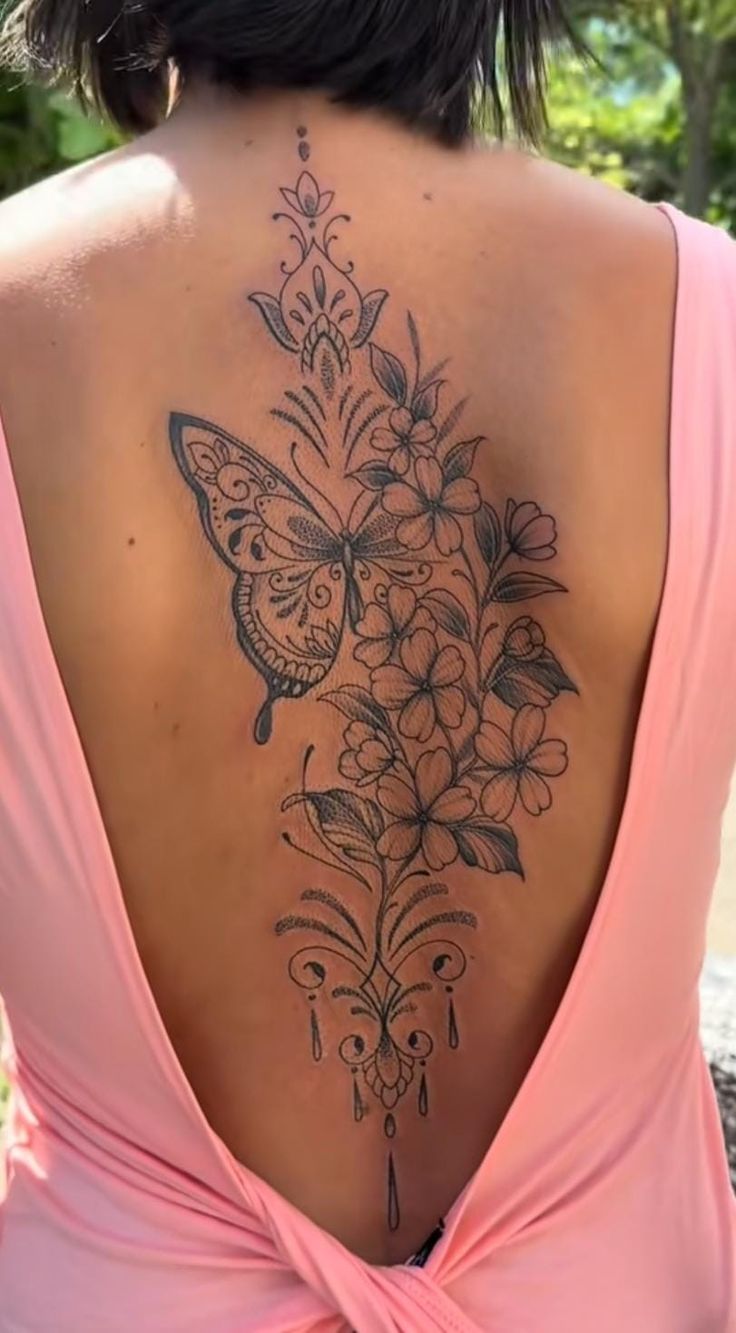 a woman with a butterfly tattoo on her back