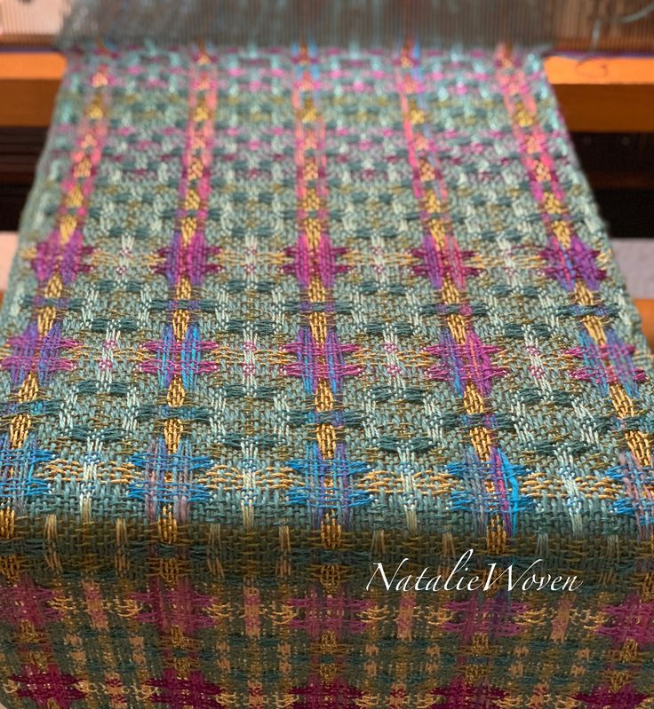 a close up of a table cloth on top of a wooden table