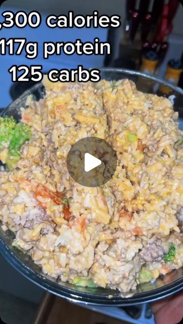 a bowl filled with rice and broccoli on top of a table