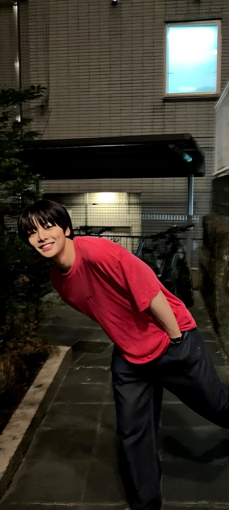 a young man riding a skateboard on top of a cement slab in front of a building