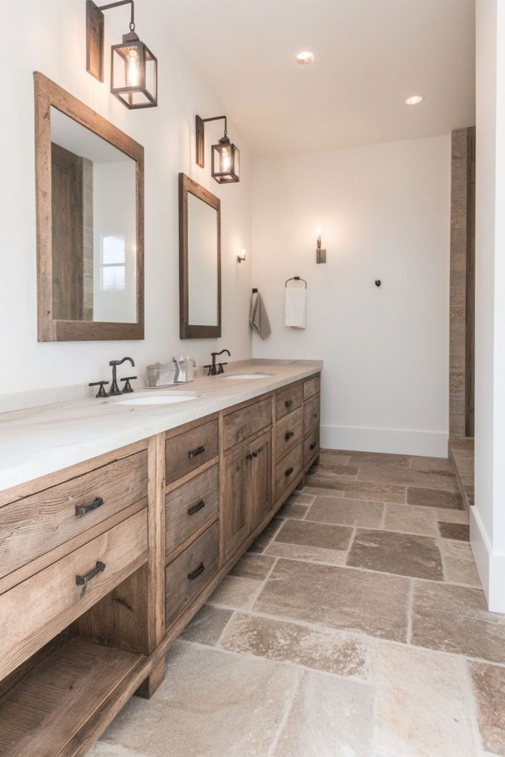 a large bathroom with two sinks and mirrors