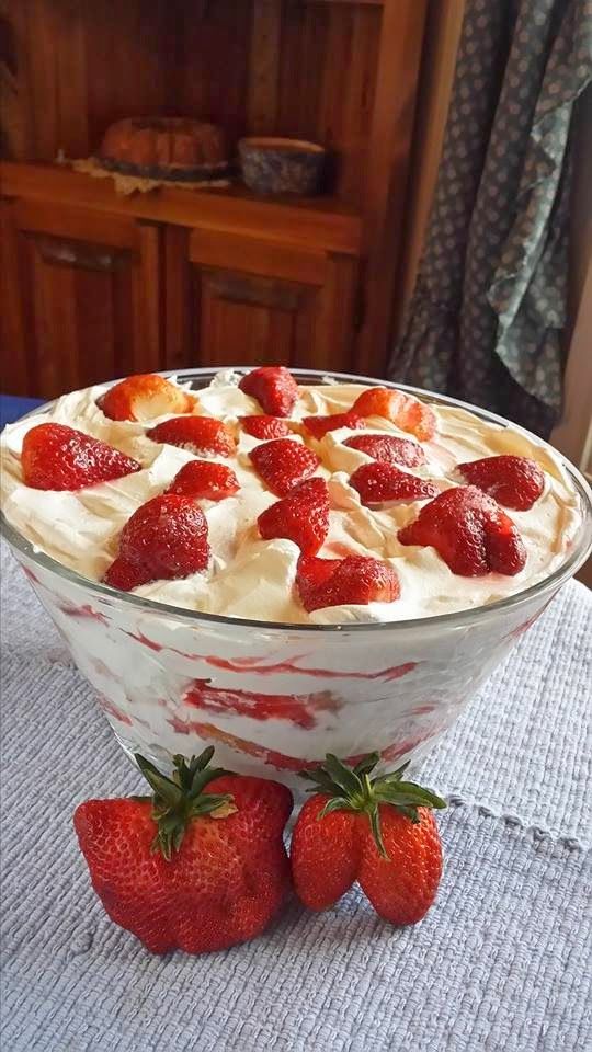 a bowl filled with strawberries on top of a table