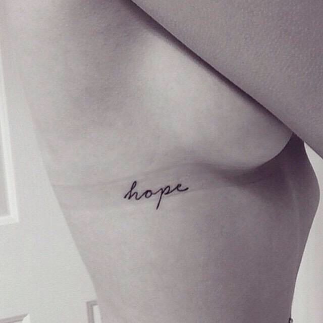 a woman's chest with the word hope written on it in cursive font