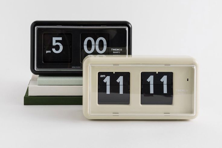 three clocks sitting on top of each other in front of a white background with black numbers