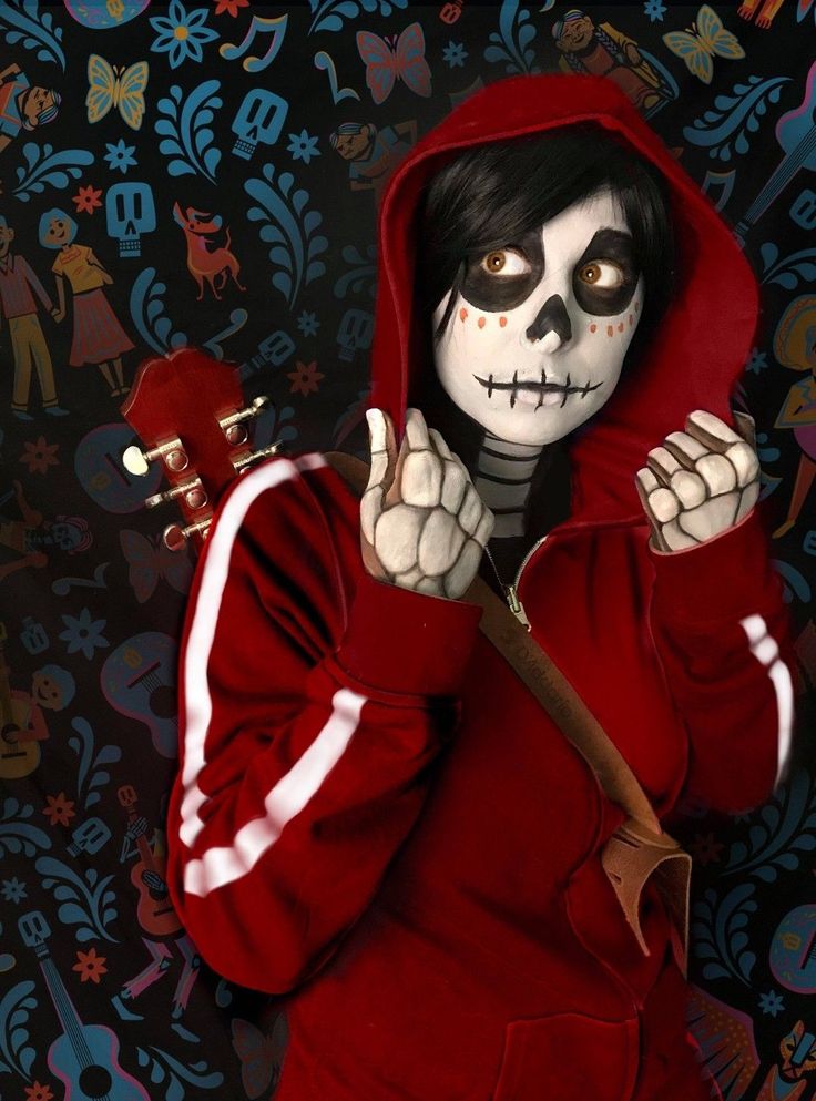 a person in a red hoodie holding a knife and making the peace sign with their hands