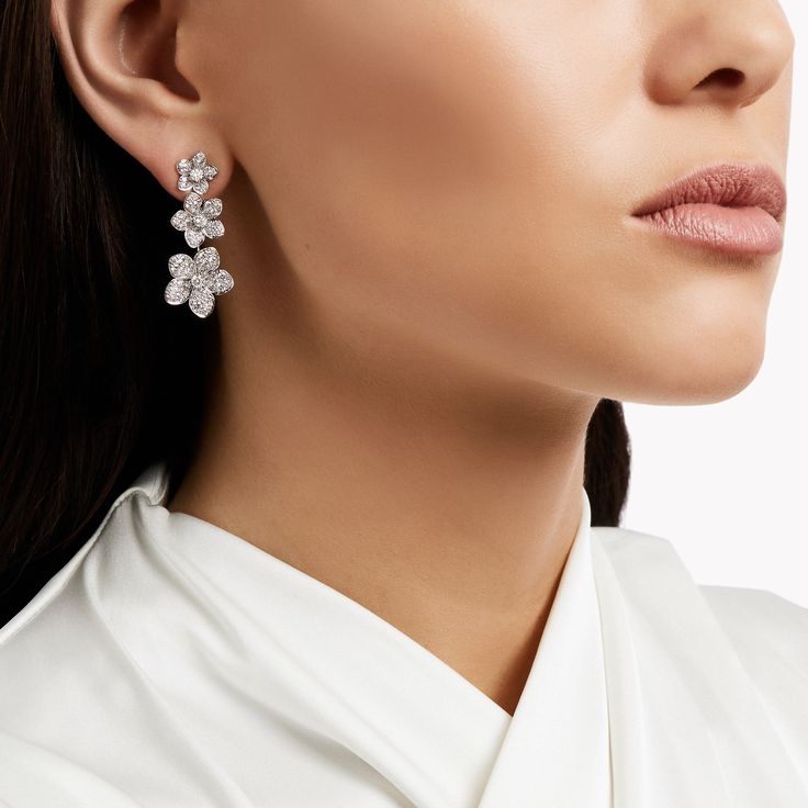 Diamond blossoms are arranged to graduate in size and arranged with carefree charm in our white gold Wild Flower diamond drop earrings. Precisely crafted by our master artisans, each flower is distinct, and every last petal uniquely realised to burst with life. The Wild Flower collection is an invitation to escape into a garden that grows just for you. From trios and individual blooms to floral clusters and blossoms laid out in a row, each Wild Flower jewel is a statement of delicacy and of empo Triple Diamond Ring, Diamond Shaped Engagement Ring, Large Diamond Rings, Galaxy Stuff, Graff Diamonds, Interesting Jewelry, Jewellery Photography, Jewelry Displays, Flower Collection