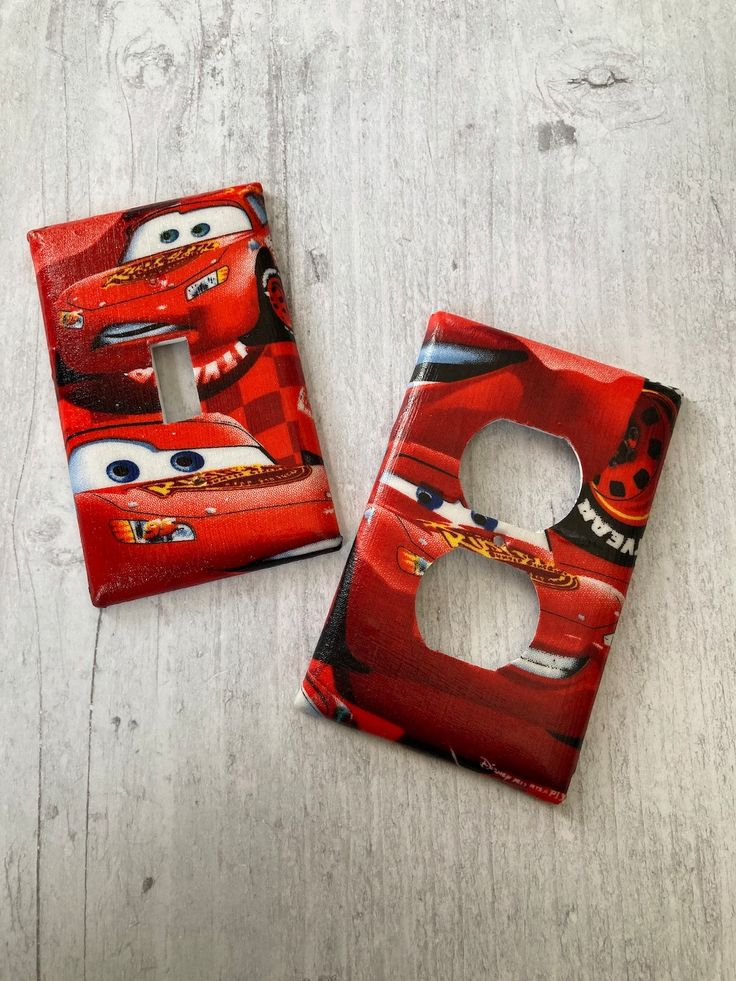 two light switch covers with cars characters on them