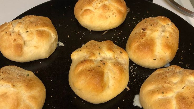 some bread rolls are cooking in a skillet