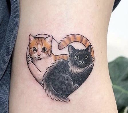 two cats sitting on top of each other in a heart shaped tattoo design with the caption cat and kitten