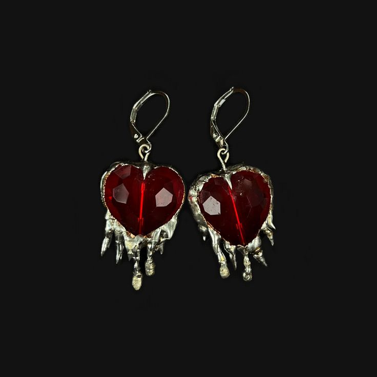 Handmade earrings with brilliant red crystal hearts and soft solder details. Inspired by the heavily encased jewels in metalwork of the Middle Ages, these reference the motif of the bleeding heart, and popular jewelry styles of the period. Hypoallergenic silver plated french earring hooks Made to order; will be unique and vary from product photo Silver Red Jewelry, Pierced Metal Heart Pendant Jewelry, Pierced Heart Pendant Jewelry, Heart Pendant Sterling Silver Jewelry For Party, Sterling Silver Heart Pendant For Party, Nickel-free Red Jewelry For Anniversary, Metal Heart Pendant Jewelry With Matching Earrings, Metal Jewelry With Matching Heart Pendant Earrings, Red Drop Beads For Jewelry Making