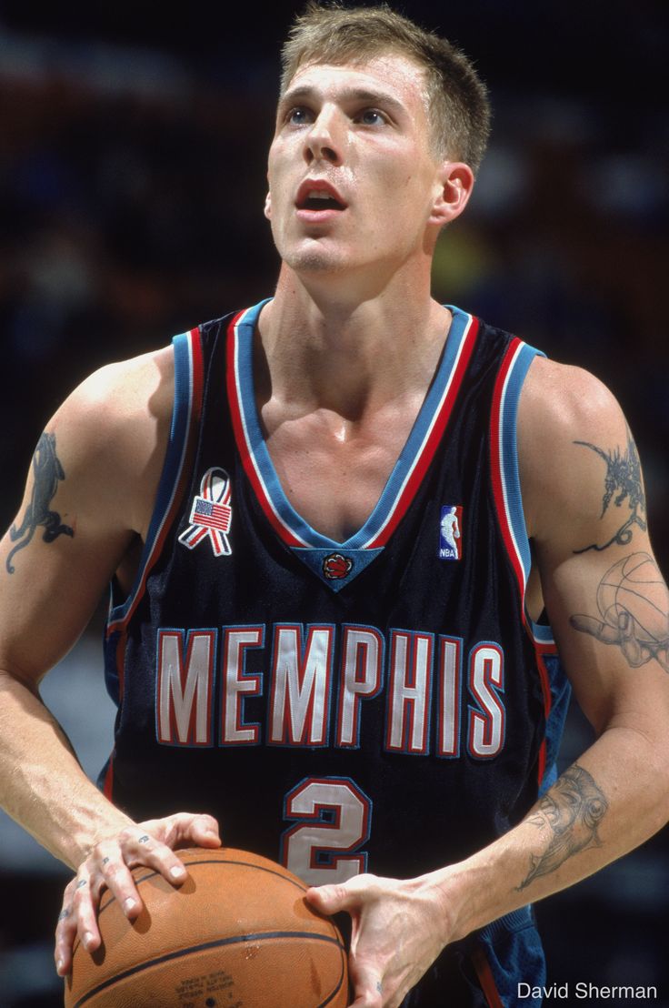 a man holding a basketball in his right hand and wearing a jersey with the number 2 on it