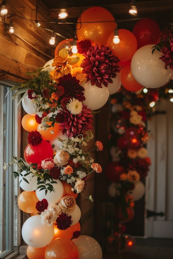 balloons and flowers are hanging from the ceiling