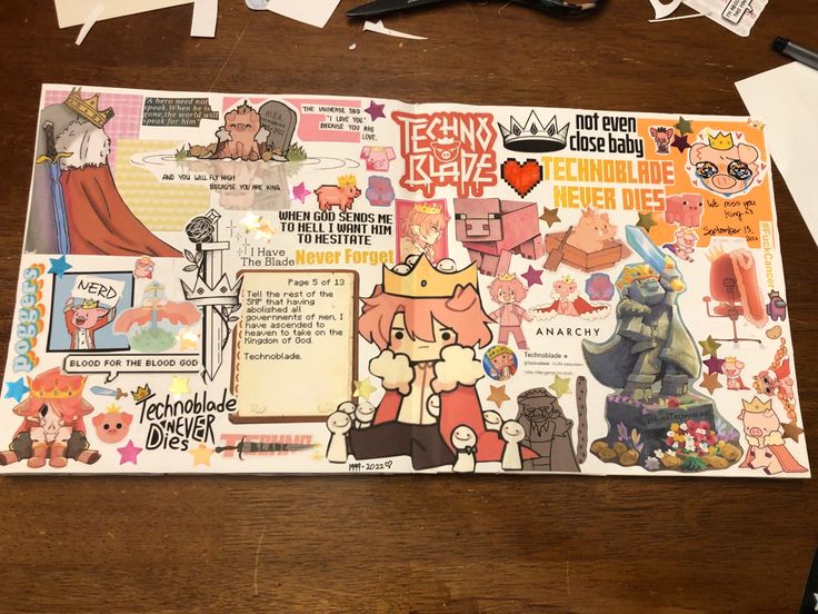 a wooden table topped with lots of stickers and paper work on top of it