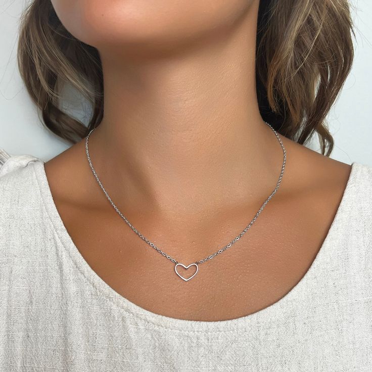 Our Heart Necklace is the epitome of understated elegance, offering a subtle yet powerful expression of love in its simplest form - a heart. This dainty heart necklace, featuring the delicate outline of a heart on a fine but sturdy chain, is more than just a piece of jewelry; it’s a symbol of the enduring nature of love in all its forms.Designed for versatility, this minimalist necklace seamlessly complements both casual and formal attire, making it a perfect choice for everyday wear or special Minimalist Delicate Chain Charm Necklace For Valentine's Day, Minimalist Pendant Chain Necklace For Valentine's Day, Minimalist Pendant Necklace For Valentine's Day, Minimalist Heart Chain Necklace With Adjustable Chain, Minimalist Heart-shaped Adjustable Chain Necklace, Delicate Open Heart Clavicle Chain Jewelry, Rose Gold Open Heart Charm Necklace, Simple Heart Pendant Necklace For Everyday, Delicate Heart Pendant Necklace With Clavicle Chain