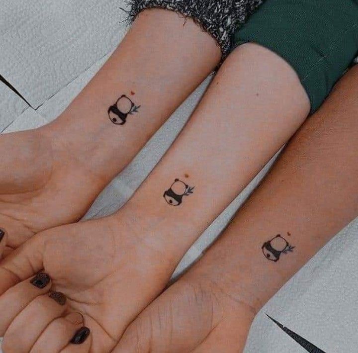 two people with matching tattoos on their arms