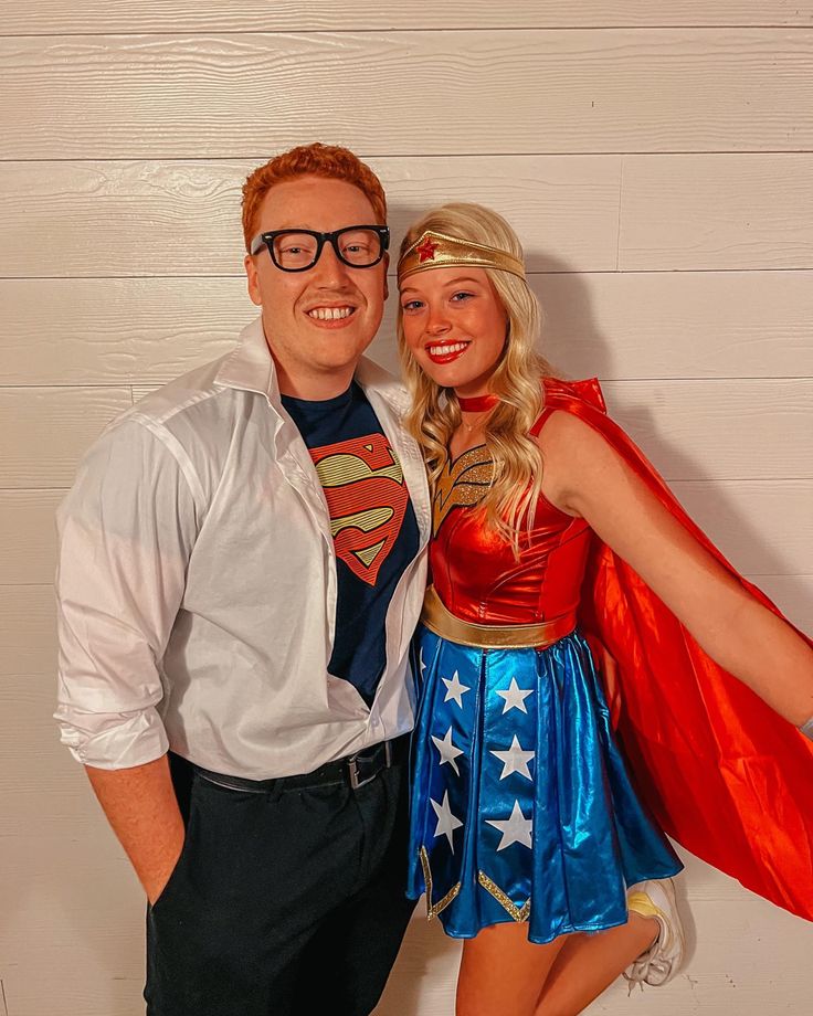 a man and woman dressed up as superman and wondergirl posing for a photo together