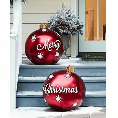 two red christmas ornaments sitting on the steps