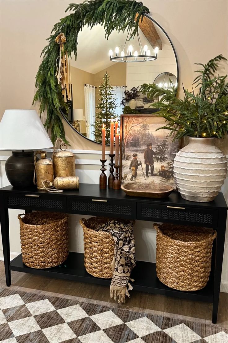 a black table with baskets and vases on it in front of a large mirror