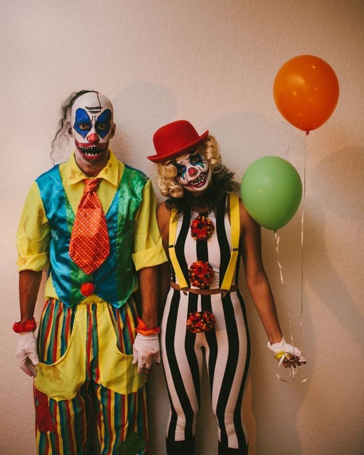 two clowns are standing next to each other