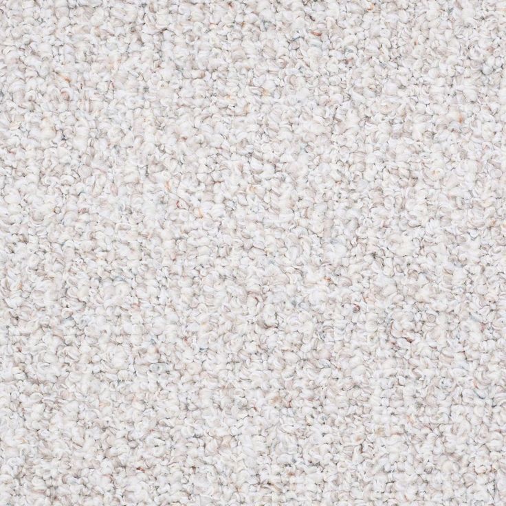 an image of a white carpet textured with small speckles on the floor